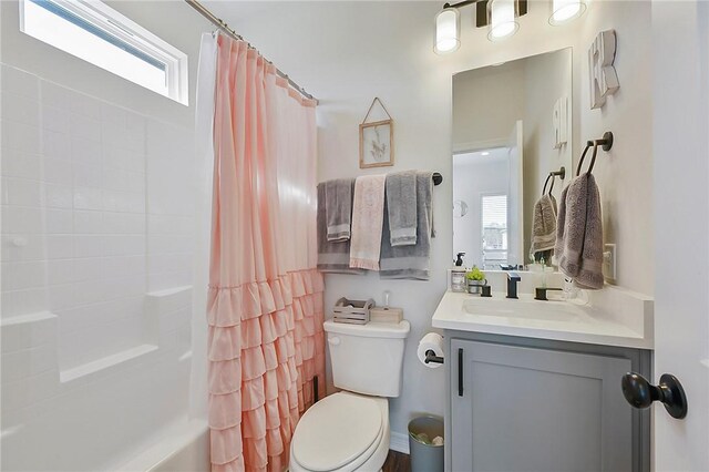 full bath featuring shower / tub combo, toilet, and vanity