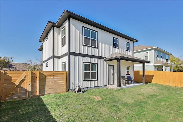 back of property featuring a fenced backyard, a patio area, board and batten siding, and a lawn