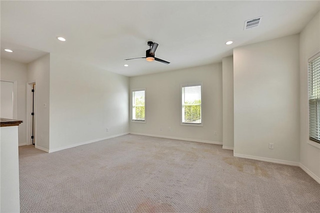 unfurnished room with light colored carpet, a ceiling fan, and recessed lighting