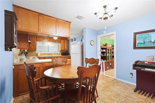 dining space with a chandelier, visible vents, and baseboards