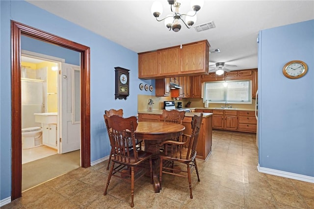 dining space with ceiling fan with notable chandelier, visible vents, and baseboards