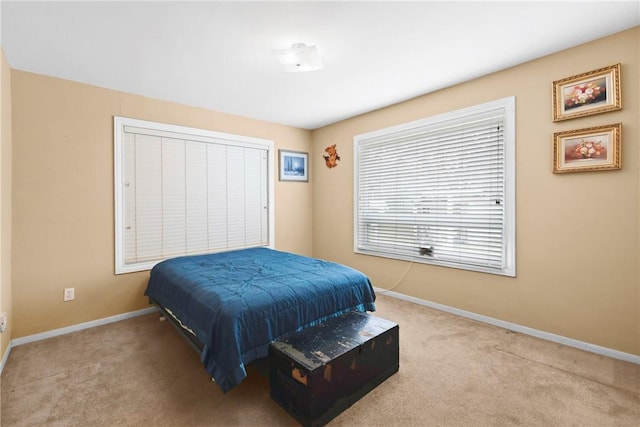 carpeted bedroom featuring baseboards