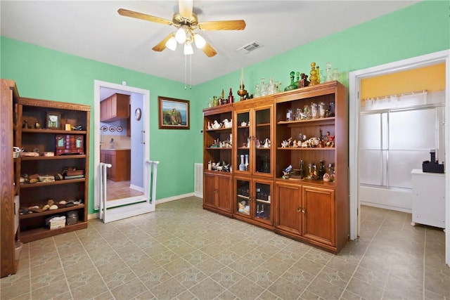 bar featuring ceiling fan, visible vents, and baseboards