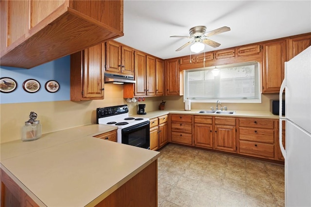 kitchen with electric stove, freestanding refrigerator, a peninsula, under cabinet range hood, and a sink