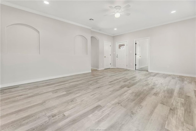 unfurnished room with crown molding, a ceiling fan, baseboards, and light wood-type flooring