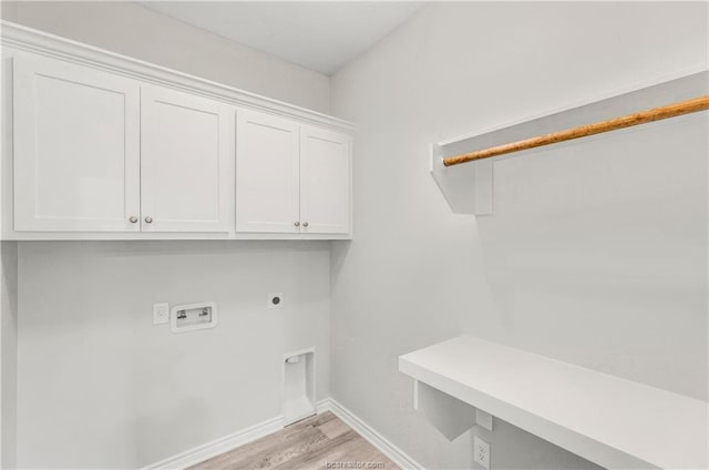 clothes washing area featuring cabinet space, washer hookup, baseboards, light wood-type flooring, and hookup for an electric dryer
