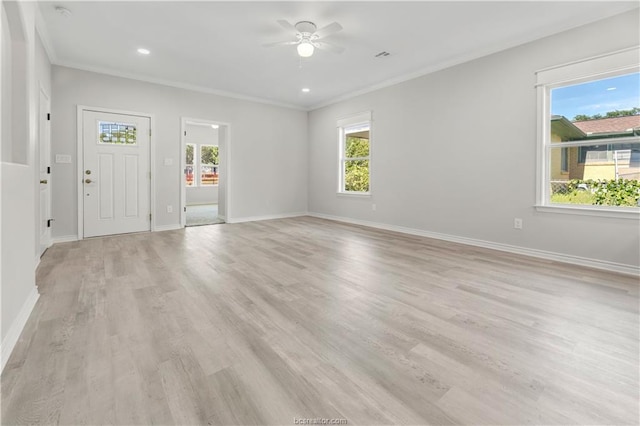 interior space featuring baseboards, plenty of natural light, light wood finished floors, and ceiling fan