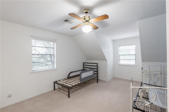 carpeted bedroom featuring ceiling fan and vaulted ceiling