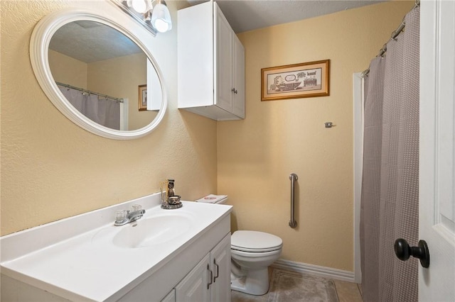 bathroom with vanity, tile patterned floors, and toilet