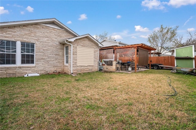 back of property with a yard and a patio