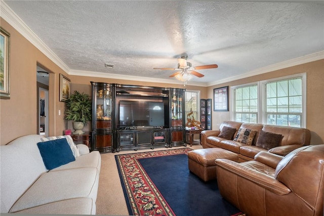 living room with ceiling fan, crown molding, carpet floors, and a textured ceiling