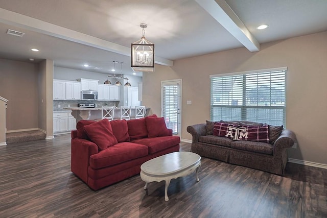 living room with beamed ceiling and dark hardwood / wood-style flooring