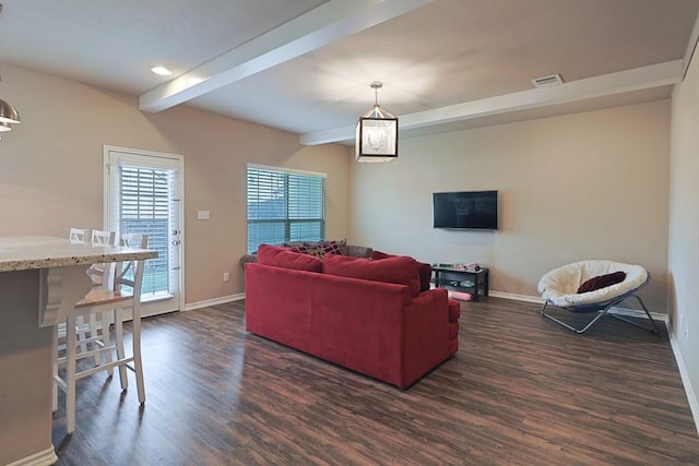 living room featuring beamed ceiling and dark hardwood / wood-style floors