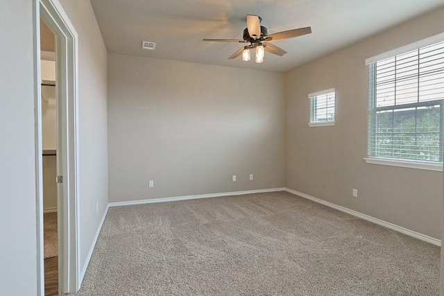 spare room with ceiling fan and carpet flooring