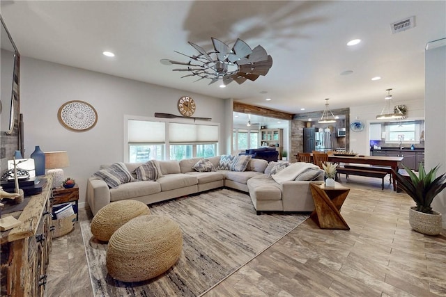 living area featuring a ceiling fan, visible vents, and recessed lighting