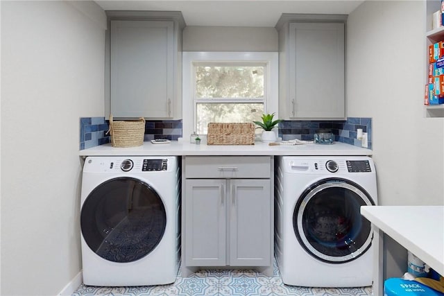 washroom featuring light tile patterned floors, cabinet space, and washer / dryer