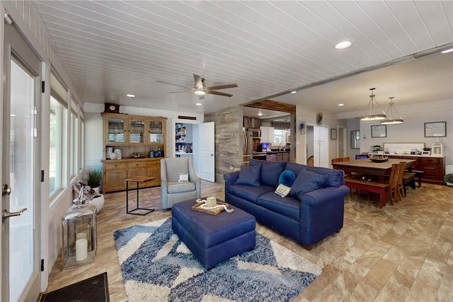 living area with a ceiling fan and recessed lighting