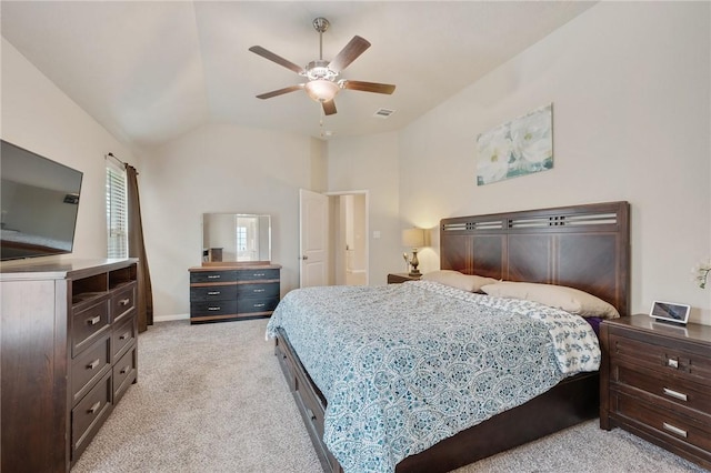 bedroom featuring lofted ceiling, light colored carpet, visible vents, baseboards, and a ceiling fan