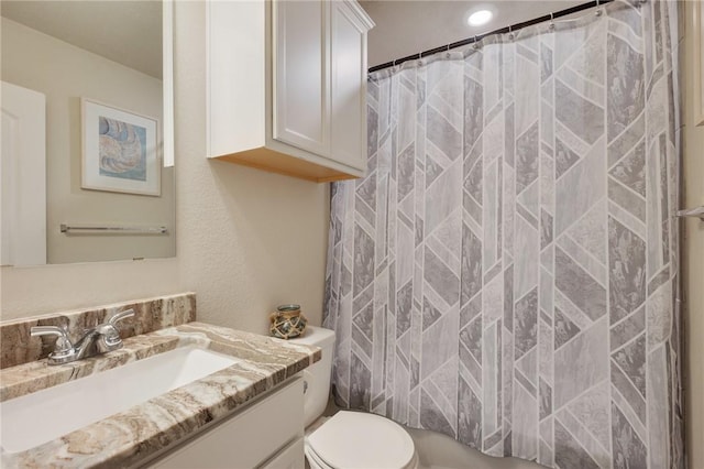 bathroom featuring vanity, toilet, and a shower with shower curtain