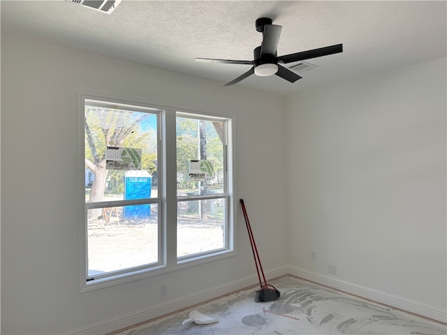 empty room featuring ceiling fan and a textured ceiling