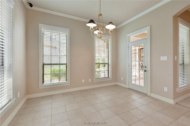 unfurnished dining area with crown molding, plenty of natural light, and a notable chandelier