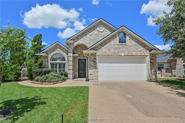 view of front of home featuring a garage and a front lawn