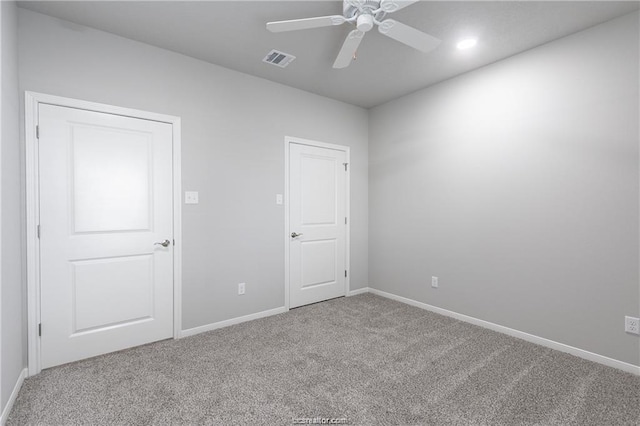 unfurnished room with ceiling fan and carpet flooring