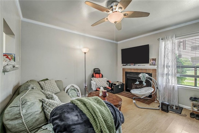 1902 Dartmouth St Unit O2, College Station, TX 77840 - living area with a tiled fireplace, wood finished floors, ceiling fan, and crown molding