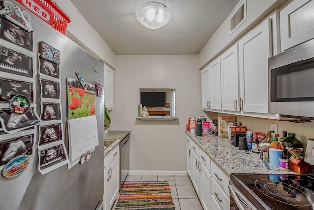 1902 Dartmouth St Unit O2, College Station, TX 77840 - kitchen featuring white cabinets, visible vents, appliances with stainless steel finishes, and light tile patterned floors