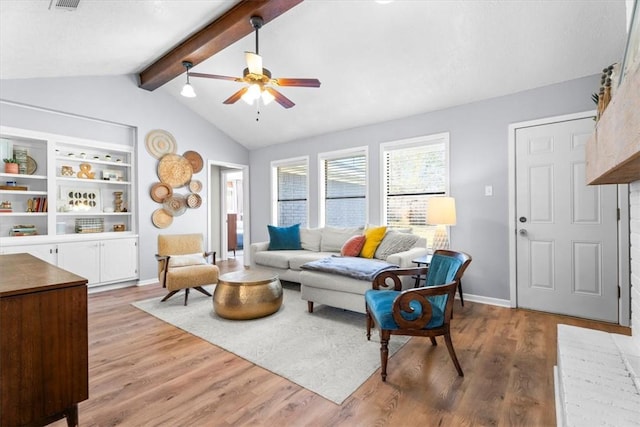 living room with vaulted ceiling with beams, light hardwood / wood-style flooring, and ceiling fan