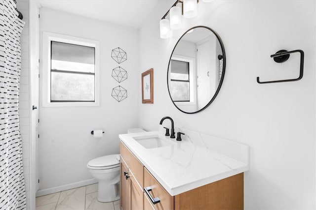 bathroom with a shower, vanity, and toilet