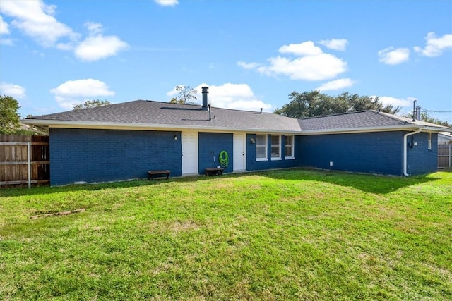 rear view of house with a lawn