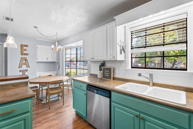 kitchen with white cabinetry, dishwasher, sink, light hardwood / wood-style floors, and a textured ceiling