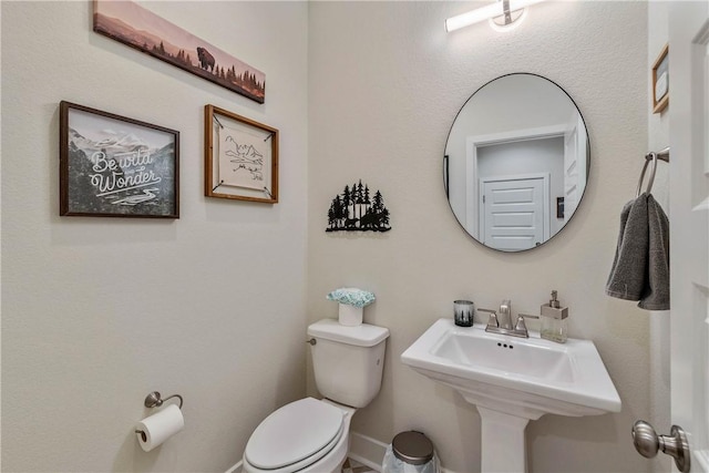 bathroom featuring toilet and sink