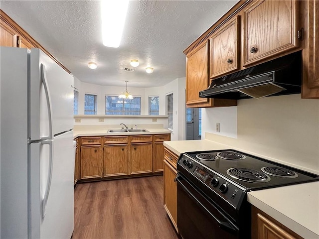 kitchen featuring sink, black / electric stove, white fridge, pendant lighting, and a chandelier