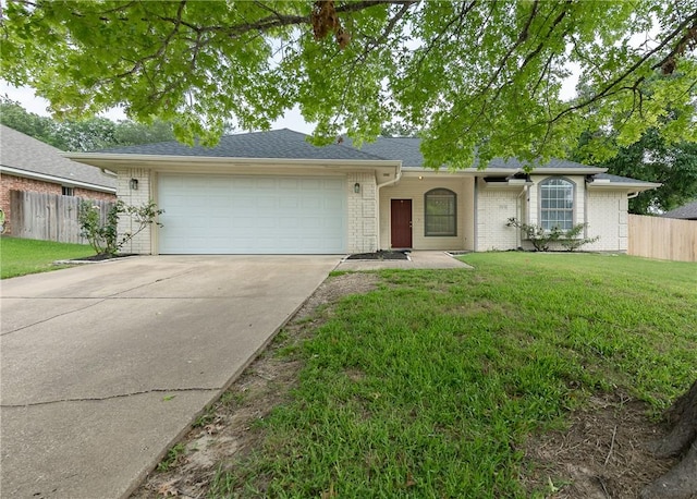 ranch-style home featuring a garage and a front lawn