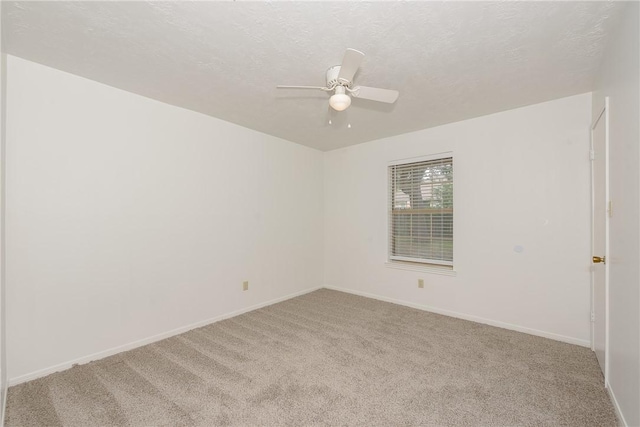 unfurnished room with a textured ceiling, carpet floors, and ceiling fan