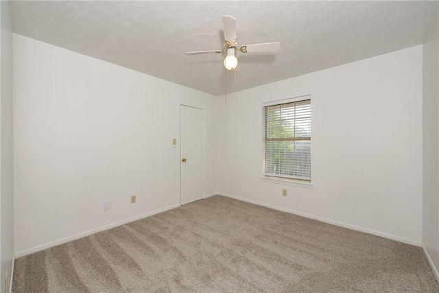 carpeted empty room with a textured ceiling and ceiling fan