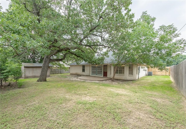 view of yard with cooling unit and a patio area