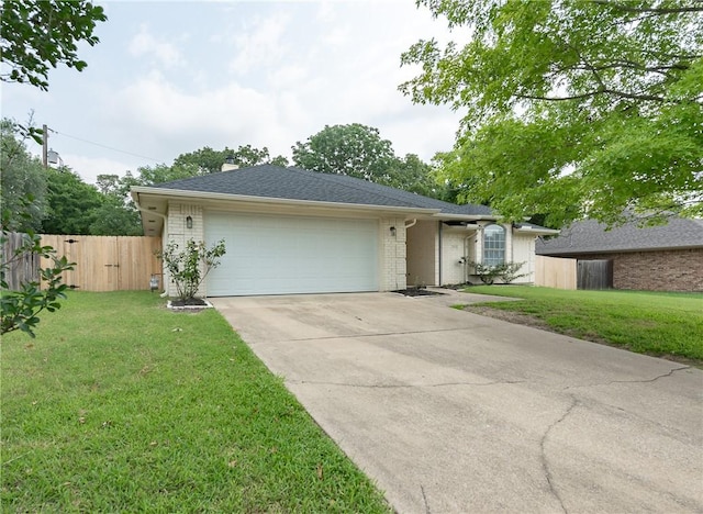 single story home featuring a garage and a front lawn