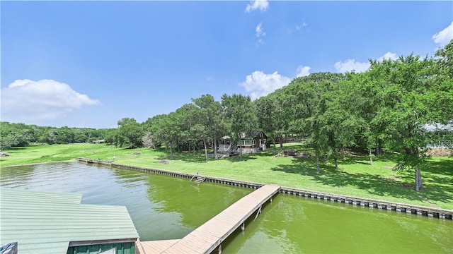 dock area with a lawn and a water view