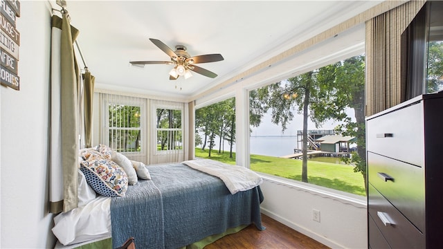 bedroom featuring a water view, baseboards, a ceiling fan, and wood finished floors