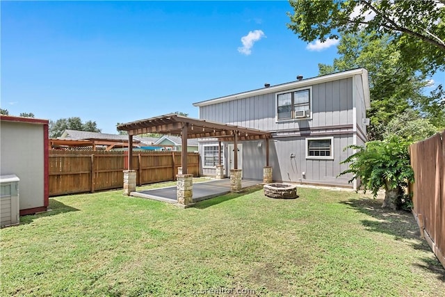 back of property featuring a lawn, a fire pit, a patio area, and a pergola