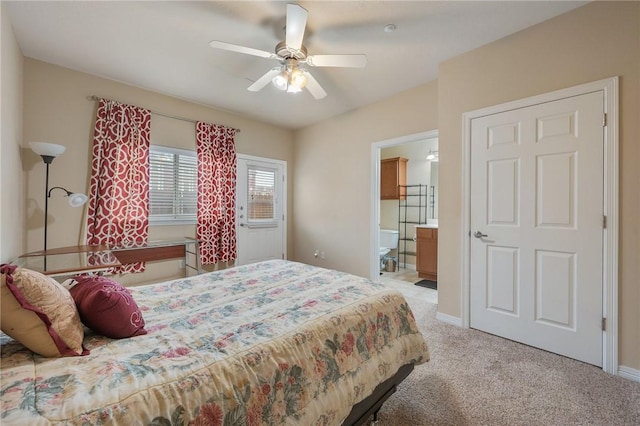 bedroom featuring connected bathroom, light carpet, and ceiling fan