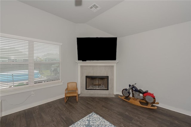 3417 Omaha Ct, Bryan, TX 77808 - living room with dark hardwood / wood-style floors, a tiled fireplace, and vaulted ceiling