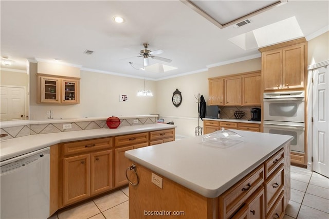 4718 Stonebriar Cir, College Station, TX 77845 - kitchen featuring a center island, white appliances, crown molding, and a skylight