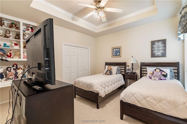 4718 Stonebriar Cir, College Station, TX 77845 - carpeted bedroom with a tray ceiling, ceiling fan, a closet, and ornamental molding