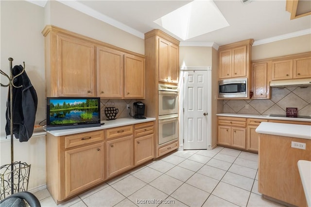 4718 Stonebriar Cir, College Station, TX 77845 - kitchen with white double oven, a skylight, stainless steel microwave, and backsplash