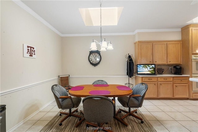 4718 Stonebriar Cir, College Station, TX 77845 - tiled dining room featuring a skylight, an inviting chandelier, and ornamental molding