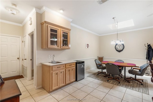 4718 Stonebriar Cir, College Station, TX 77845 - kitchen with crown molding, sink, a skylight, light tile patterned floors, and stainless steel appliances